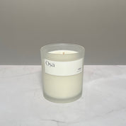 A candle on a countertop with a label displaying Osa 1992.