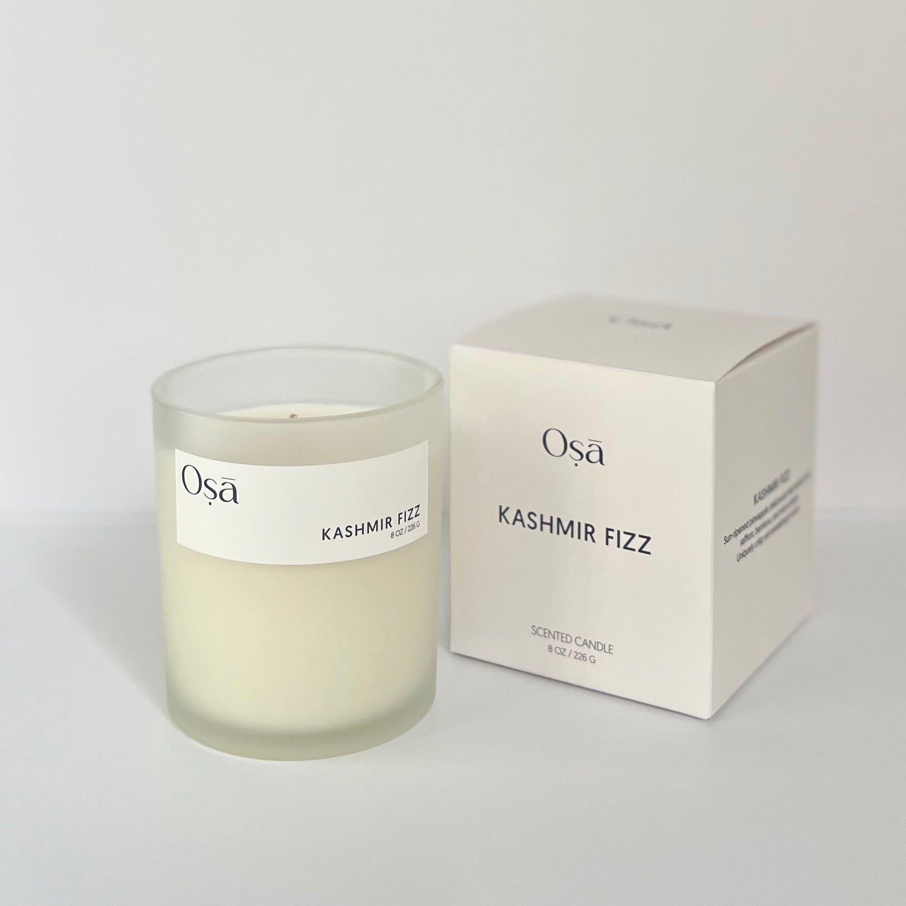 A candle and box with a label displaying Osa Kashmir Fizz.