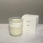 A candle and box with a label displaying Osa 1992.